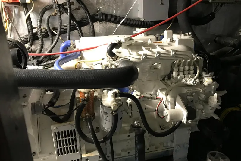 Slide: The Image of Engine room of a 1976 Hatteras 53 Convertible yacht, showcasing mechanical components. - 33