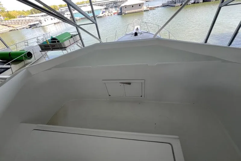 Slide: The Image of 1976 Hatteras 53 Convertible yacht deck overlooking marina with boats and water. - 5