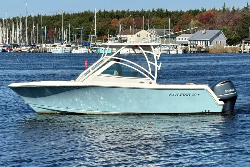 The Image of 2018 Sailfish 245 DC boat on water, with marina and trees in background. - 0
