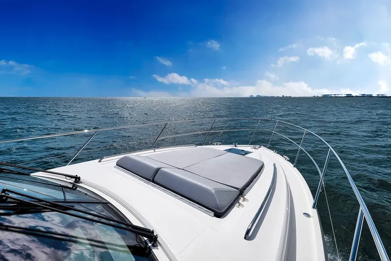 Slide: The Image of 2015 Princess V48 yacht cruising on open sea under clear blue sky. - 19