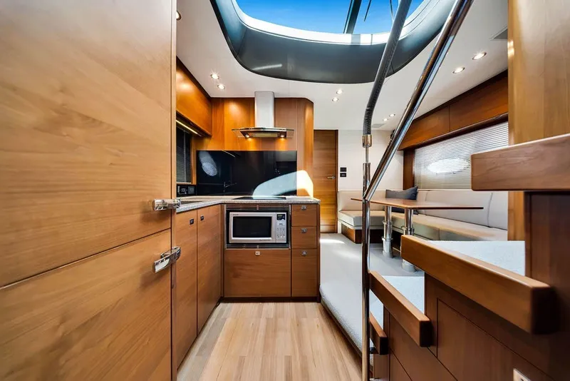 Slide: The Image of Luxurious interior of 2015 Princess V48 yacht with modern kitchen and seating area. - 32