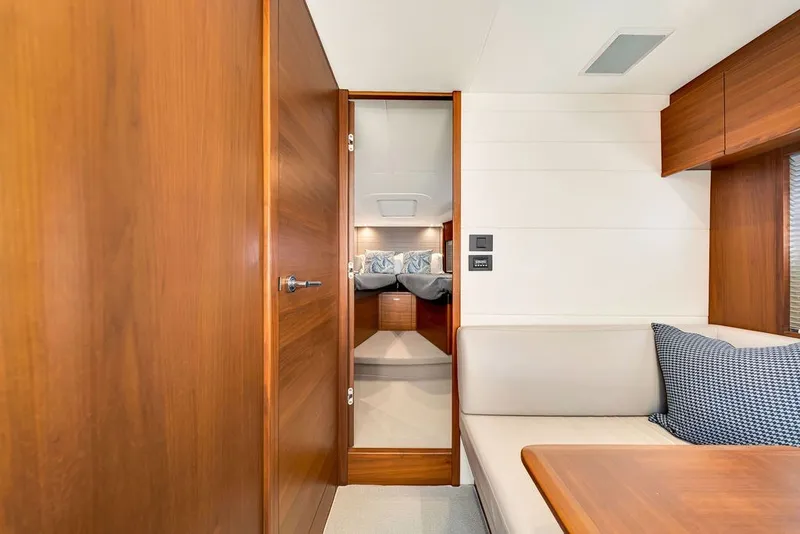 Slide: The Image of Luxurious interior of 2015 Princess V48 yacht with wooden finishes and cozy seating area. - 48