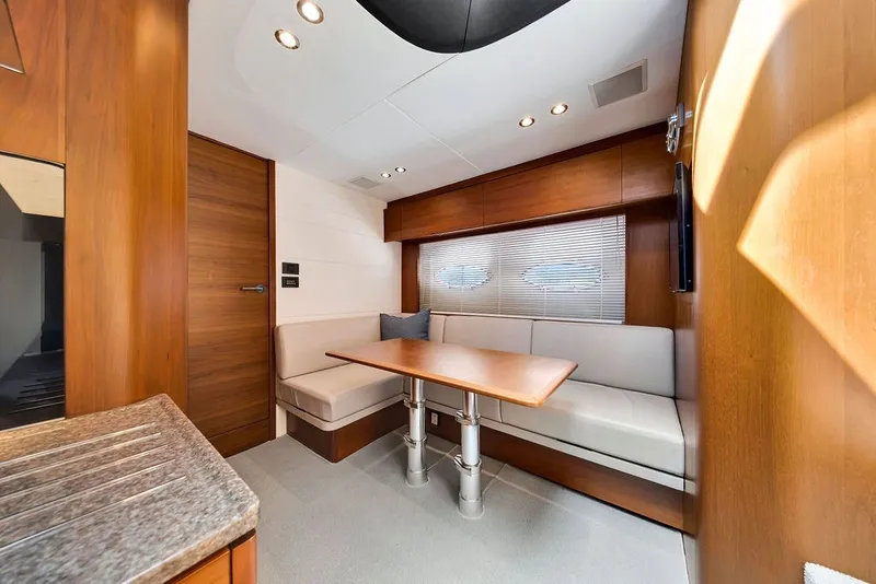 Slide: The Image of Luxurious interior of 2015 Princess V48 yacht with elegant wood finishes and cozy seating area. - 37