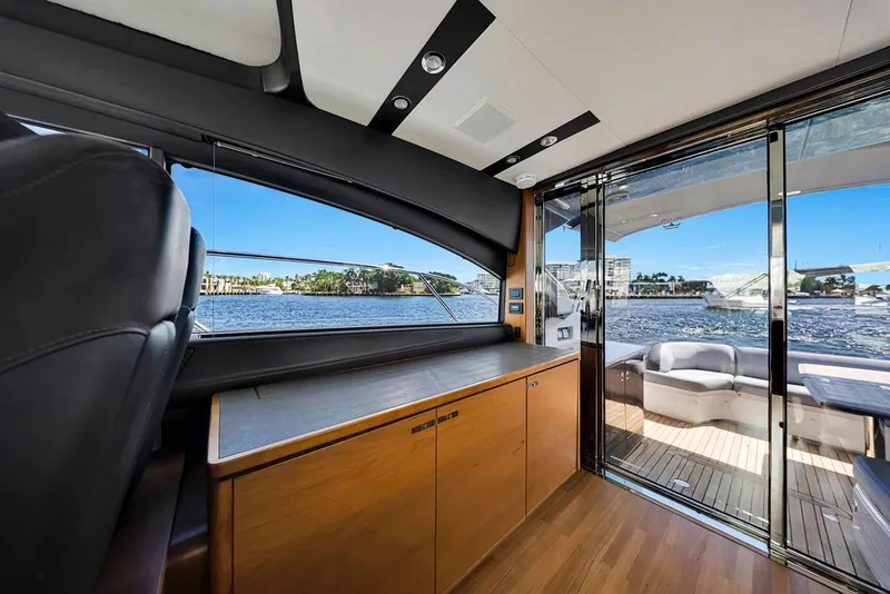 Slide: The Image of Luxurious interior of 2015 Princess V48 yacht with waterfront view through glass doors. - 25