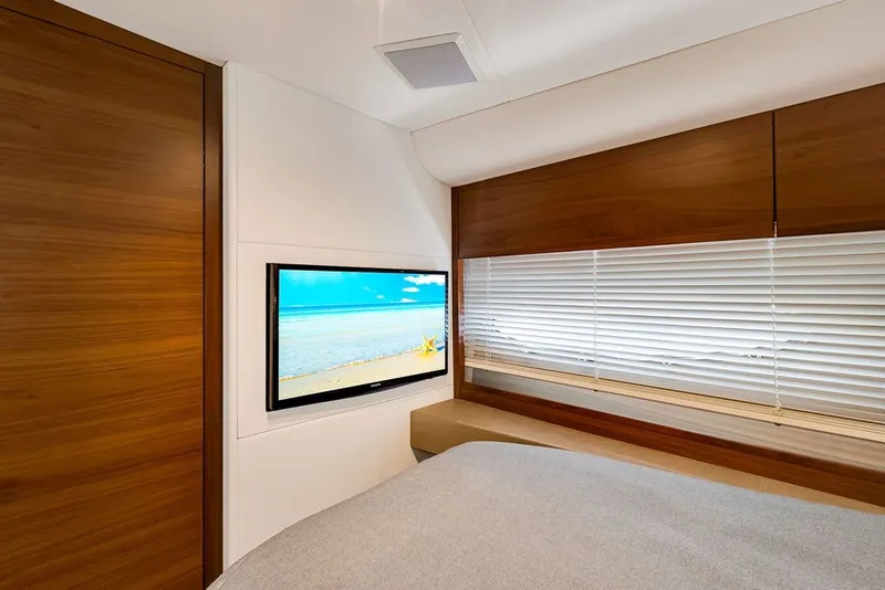 Slide: The Image of Luxurious interior of 2015 Princess V48 yacht with TV and wooden accents. - 51