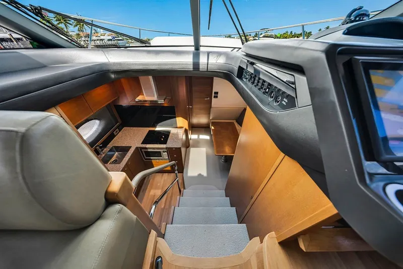 Slide: The Image of Interior view of 2015 Princess V48 yacht, showcasing modern kitchen and control panel. - 30