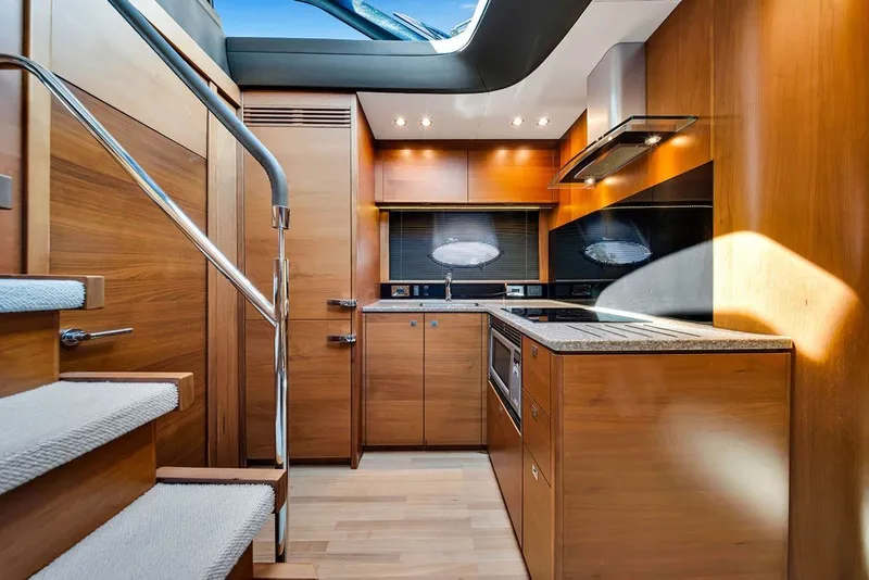 Slide: The Image of Luxurious 2015 Princess V48 yacht interior kitchen with modern wood cabinetry and sleek design. - 35