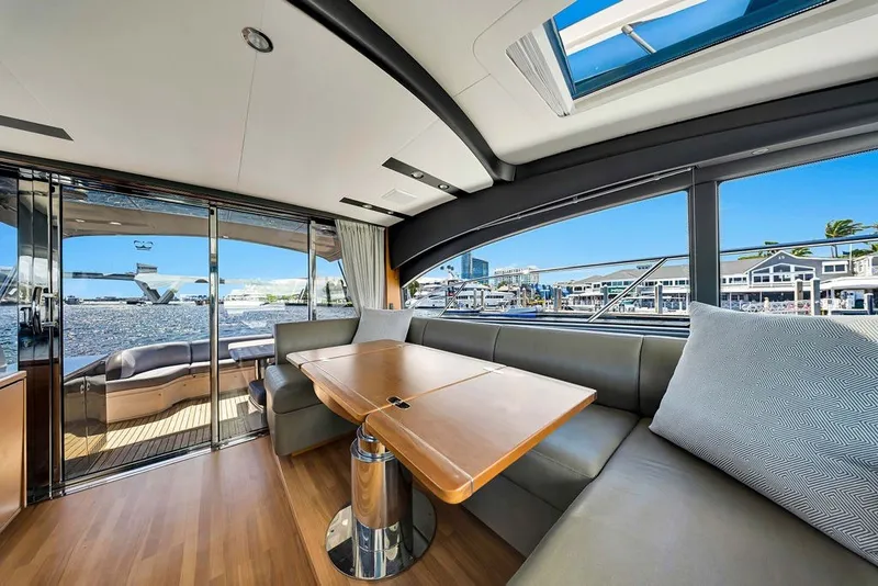 Slide: The Image of Luxurious interior of 2015 Princess V48 yacht with waterfront view and elegant seating area. - 21