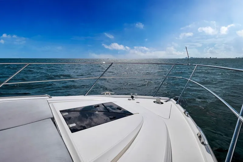 Slide: The Image of 2015 Princess V48 yacht cruising on open sea under clear blue sky. - 20