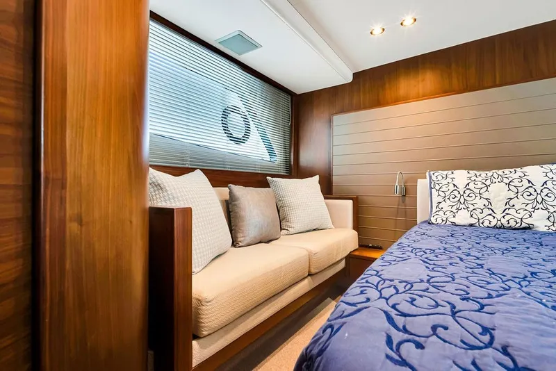 Slide: The Image of Luxurious interior of 2015 Princess V48 yacht with elegant bedding and cozy seating area. - 42