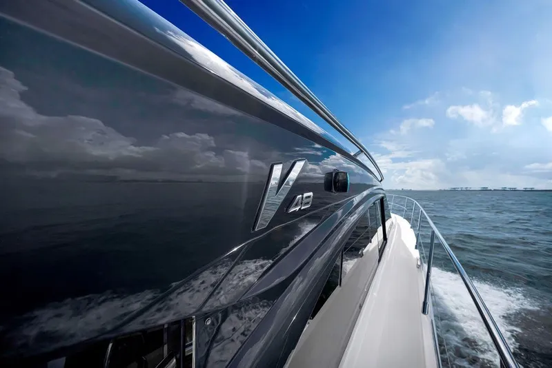 Slide: The Image of 2015 Princess V48 yacht cruising on open water under a clear blue sky. - 18
