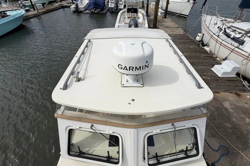 Slide: The Image of 2017 Eastern Boats Seaway Offshore docked, featuring Garmin radar on the roof. - 8