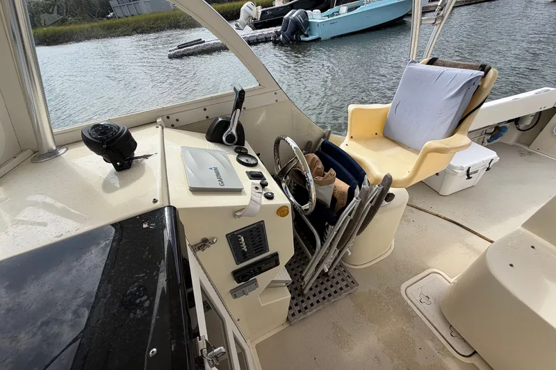 Slide: The Image of 2017 Seaway Offshore boat cockpit with steering wheel, Garmin device, and cushioned seat by Eastern Boats Inc. - 16