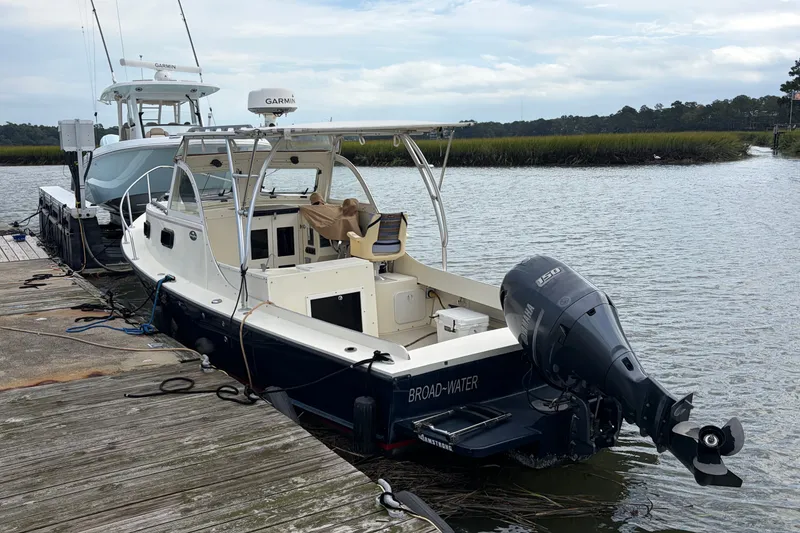 Slide: The Image of 2017 Eastern Boats Inc. Seaway Offshore docked, featuring Yamaha outboard motor, calm waters, and scenic backdrop. - 2