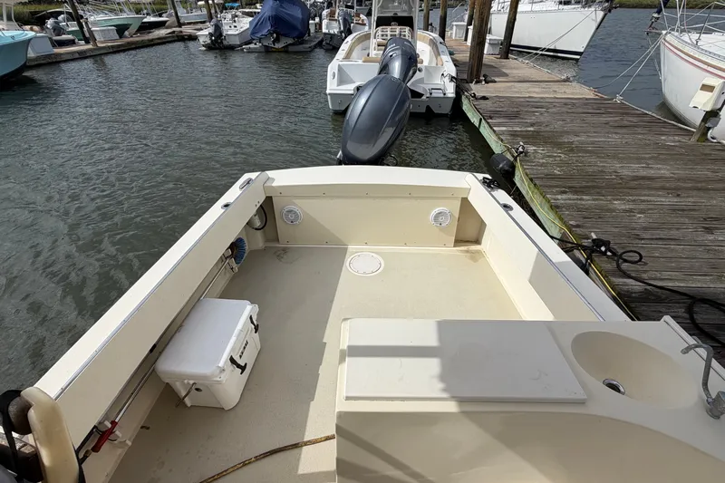 Slide: The Image of 2017 Eastern Boats Seaway Offshore docked, showcasing spacious deck and outboard motor. - 10