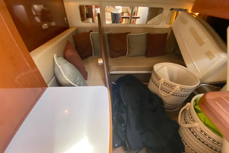 Slide: The Image of Interior of 2012 Sea Ray 330 Sundancer with seating, cushions, and storage baskets. - 32