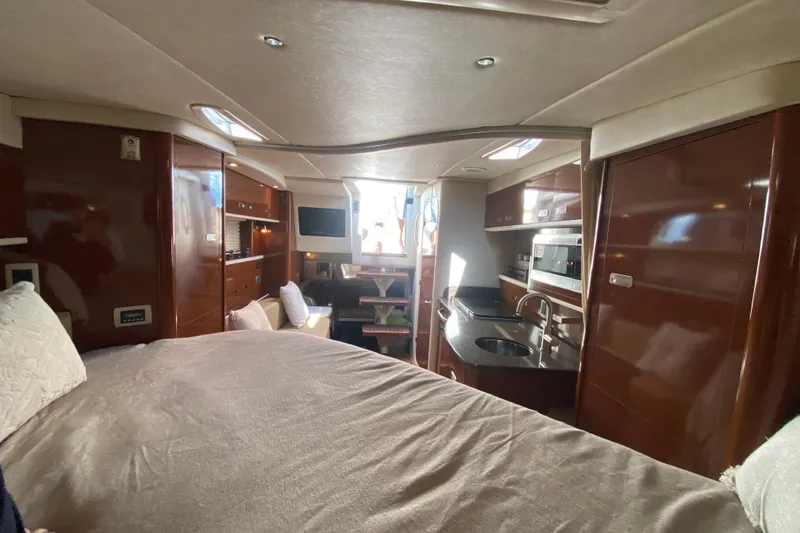 Slide: The Image of Interior of 2012 Sea Ray 330 Sundancer yacht with modern kitchen and cozy seating area. - 31