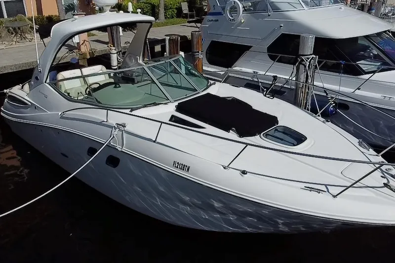 The Image of 2012 Sea Ray 330 Sundancer yacht docked at marina, side view. - 0