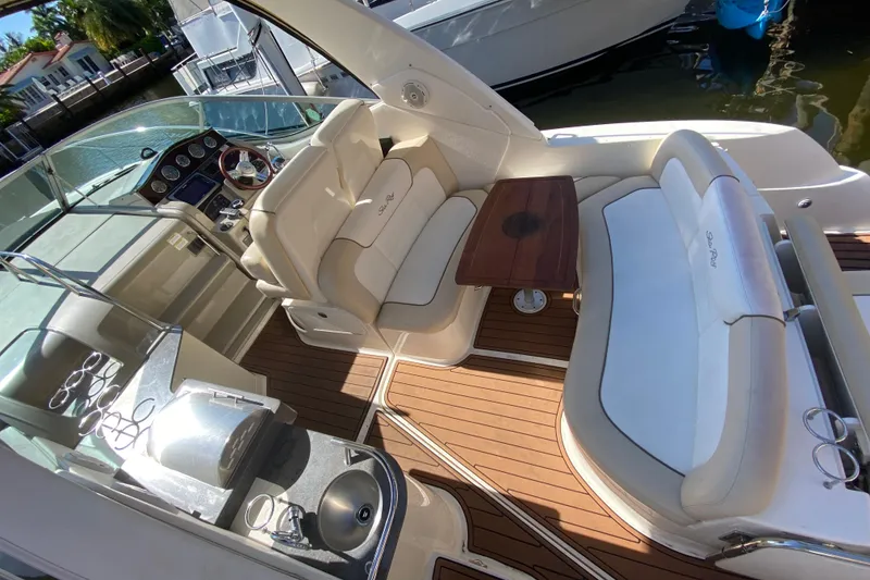 Slide: The Image of Luxurious 2012 Sea Ray 330 Sundancer yacht interior with seating, table, and helm. - 15