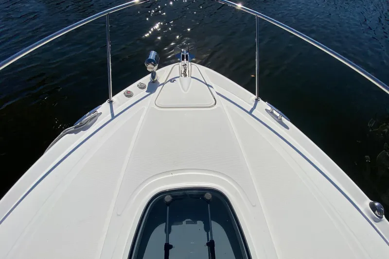 Slide: The Image of Bow of 2012 Sea Ray 330 Sundancer yacht on calm water. - 11