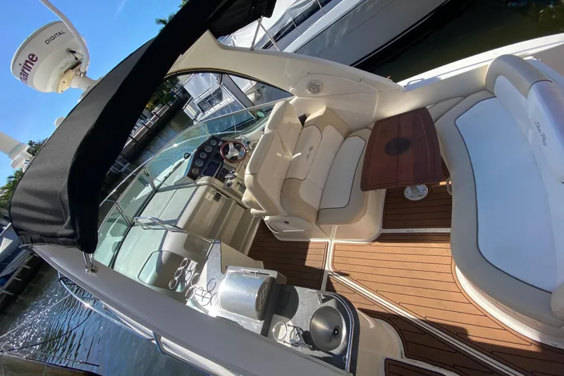 Slide: The Image of Luxurious 2012 Sea Ray 330 Sundancer yacht interior with seating and wooden deck. - 16
