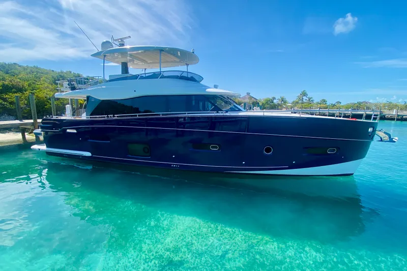 The Image of Luxurious 2018 Azimut Magellano 66 yacht docked in clear turquoise waters. - 1