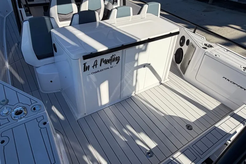 Slide: The Image of 2023 Axopar 28 T-Top boat deck with seating and storage, labeled "In A Meeting." - 30