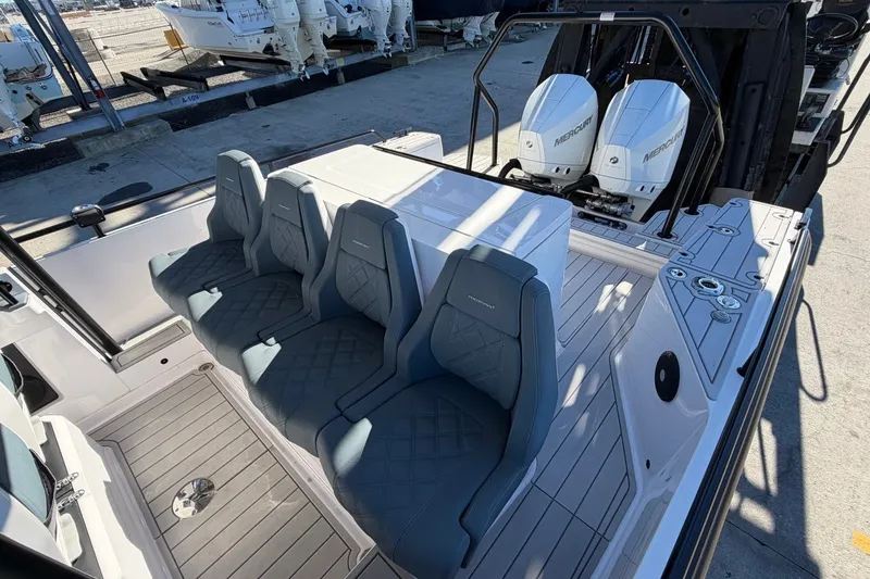 Slide: The Image of 2023 Axopar 28 T-Top boat interior with seating and dual Mercury engines. - 28