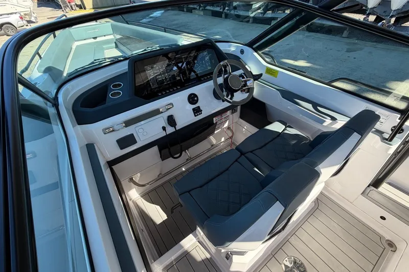 Slide: The Image of 2023 Axopar 28 T-Top boat cockpit with modern steering and seating. - 23