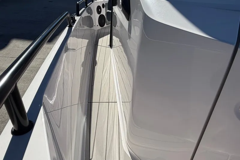 Slide: The Image of 2023 Axopar 28 T-Top boat deck with sleek design and modern railing. - 16