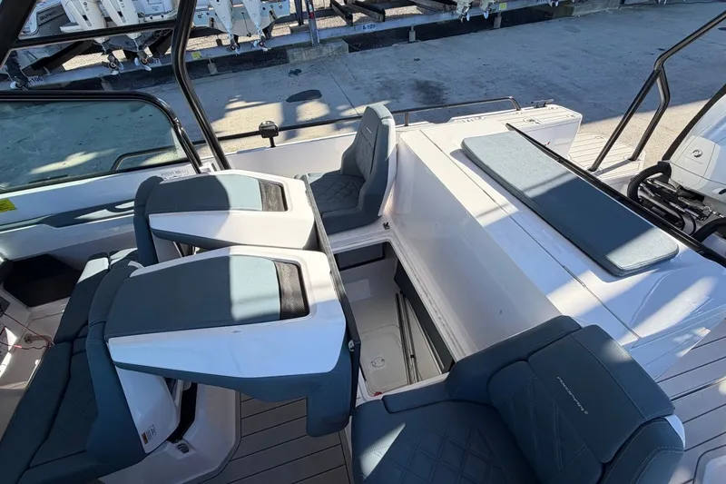 Slide: The Image of 2023 Axopar 28 T-Top boat interior with modern seating and sleek design. - 25