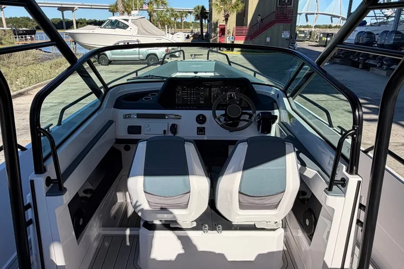 Slide: The Image of 2023 Axopar 28 T-Top boat cockpit with dual seats and modern controls. - 19