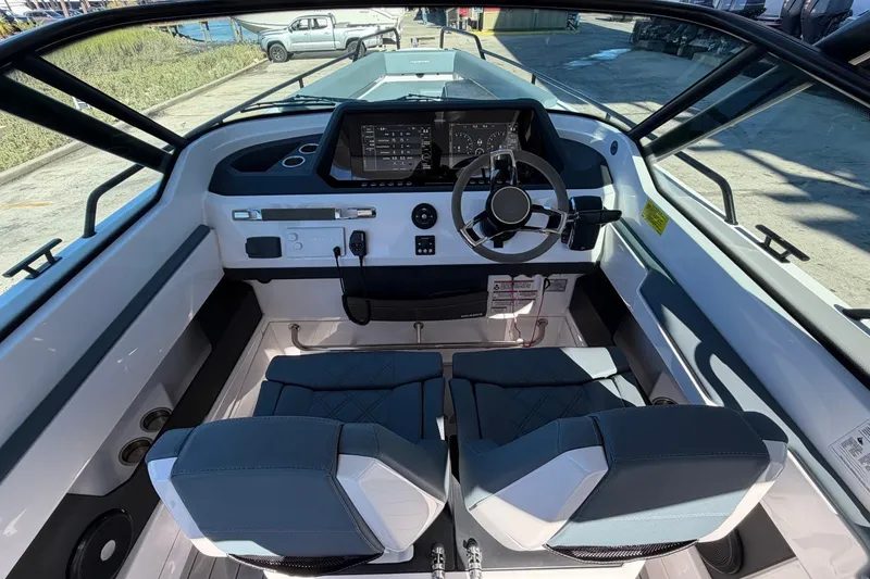 Slide: The Image of Interior view of 2023 Axopar 28 T-Top boat cockpit with modern steering and controls. - 20
