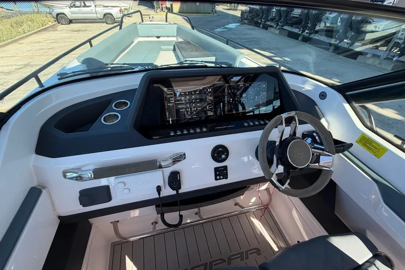 Slide: The Image of 2023 Axopar 28 T-Top boat dashboard with modern steering and digital display. - 21