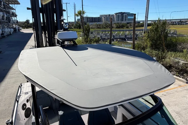 Slide: The Image of 2023 Axopar 28 T-Top boat with sleek design, docked outdoors. - 18