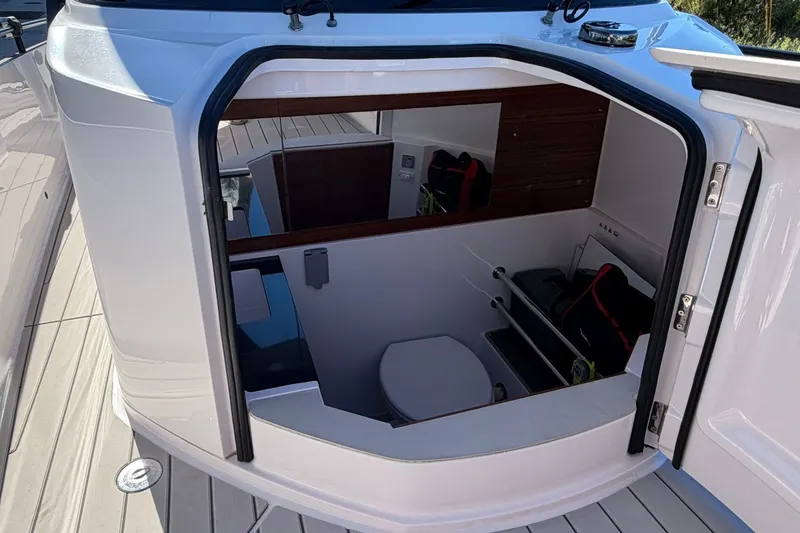 Slide: The Image of 2023 Axopar 28 T-Top cabin interior with seating and storage. - 14