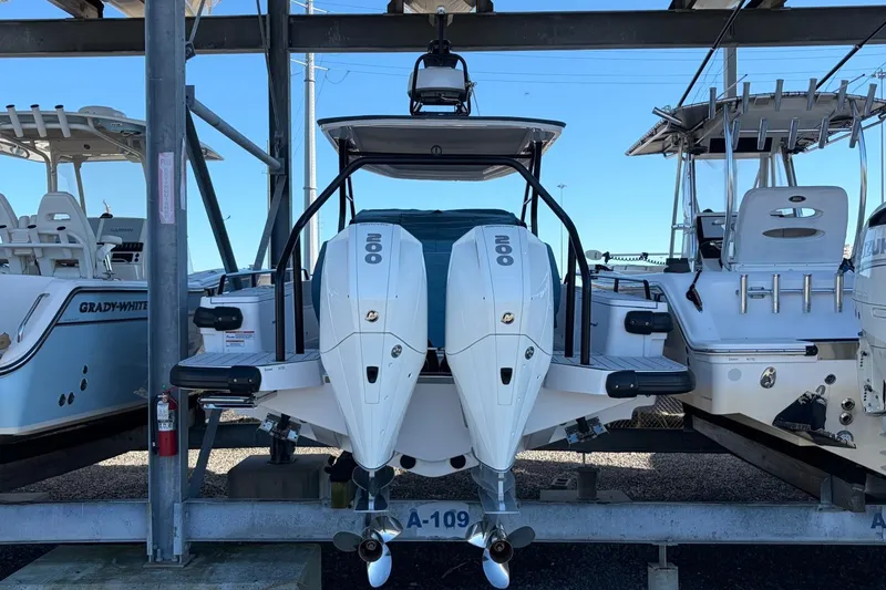 Slide: The Image of 2023 Axopar 28 T-Top boat with dual engines on display in a marina. - 34