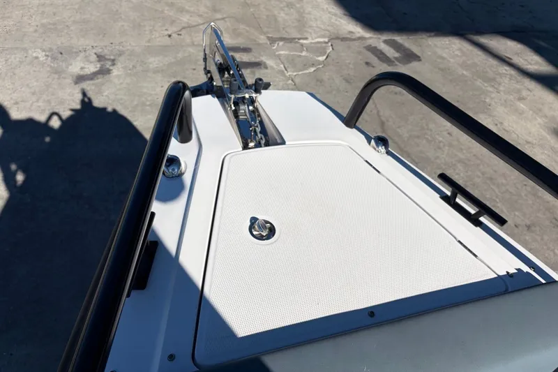 Slide: The Image of Bow view of 2023 Axopar 28 T-Top boat, featuring sleek design and sturdy railings. - 9