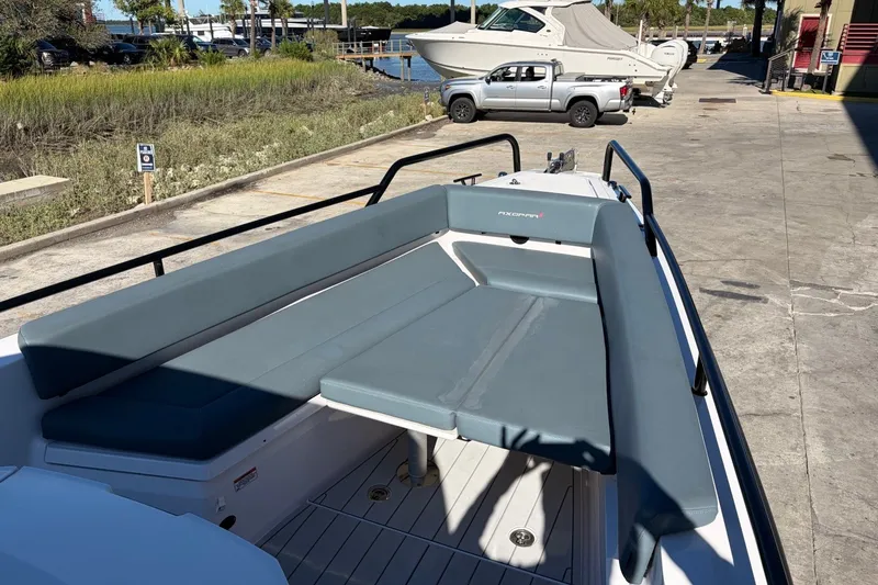 Slide: The Image of 2023 Axopar 28 T-Top boat with spacious seating, docked outdoors. - 8