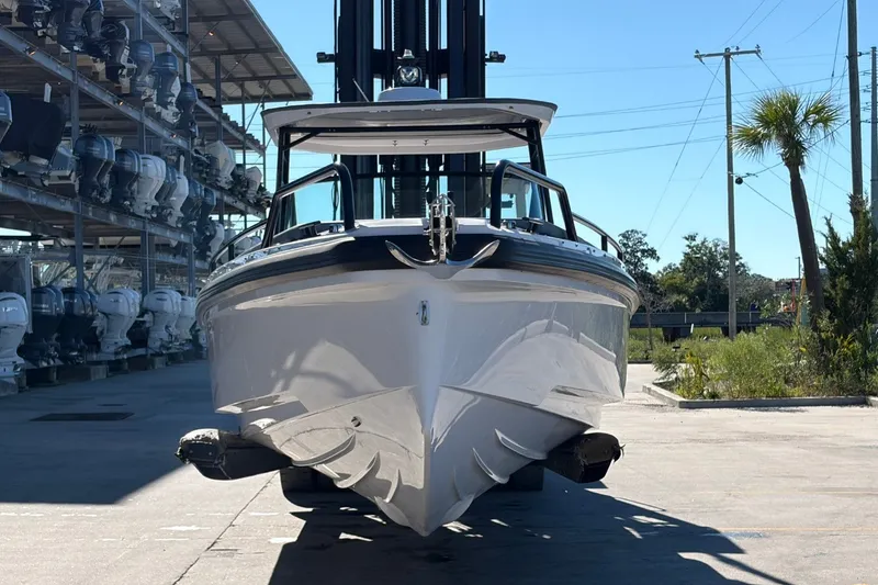 Slide: The Image of 2023 Axopar 28 T-Top boat in storage facility, front view. - 2