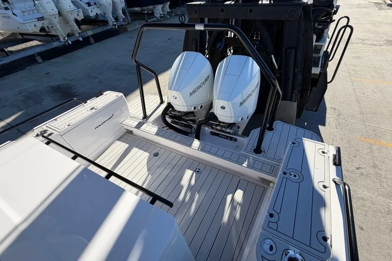 Slide: The Image of 2023 Axopar 28 T-Top boat with dual Mercury outboard engines on deck. - 29