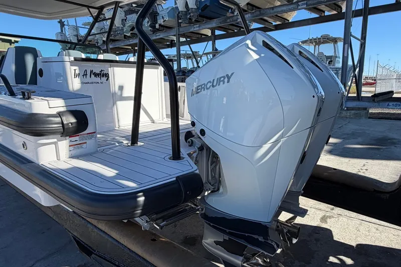 Slide: The Image of 2023 Axopar 28 T-Top boat with dual Mercury outboard engines, docked in Charleston. - 6