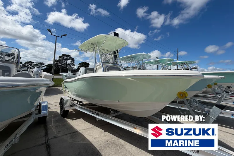 The Image of 2027 Pioneer 202 Sportfish boat on trailer, powered by Suzuki Marine, under a blue sky. - 0