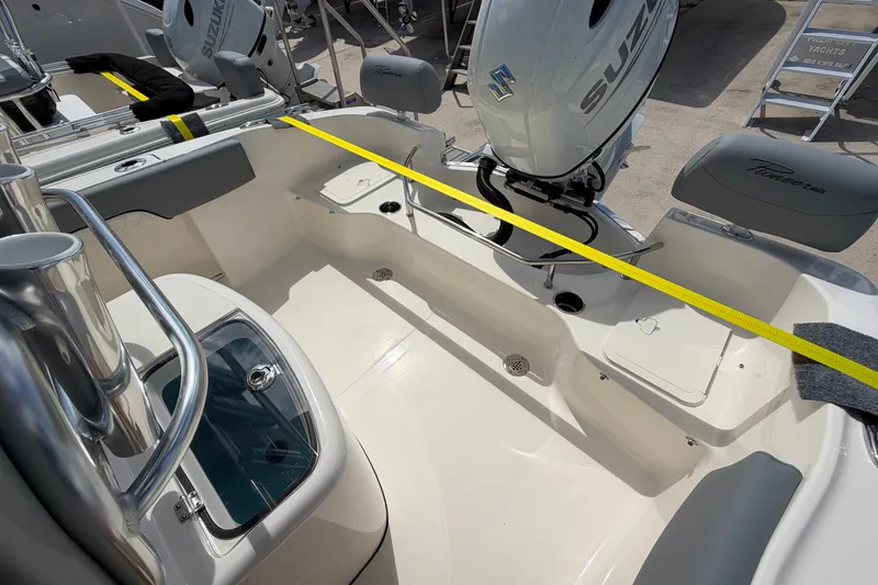 Slide: The Image of 2027 Pioneer 202 Sportfish boat interior with Suzuki engine, showcasing seating and storage areas. - 14