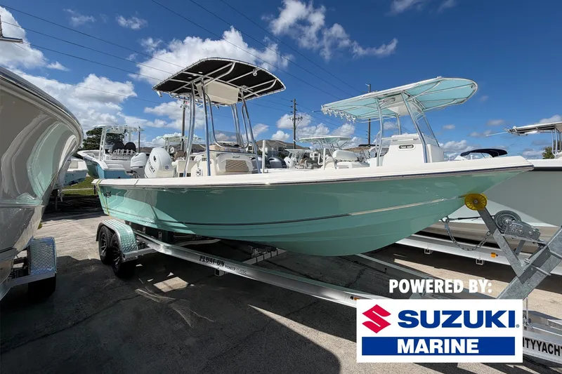 The Image of 2027 Bulls Bay 2200 XS boat on trailer, powered by Suzuki Marine, under clear blue sky. - 0