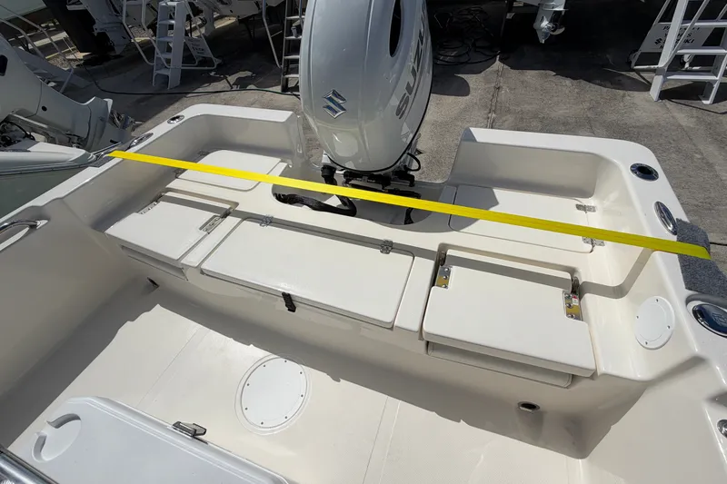 Slide: The Image of 2027 Bulls Bay 2200 XS boat interior with Suzuki engine, featuring seating and storage compartments. - 17