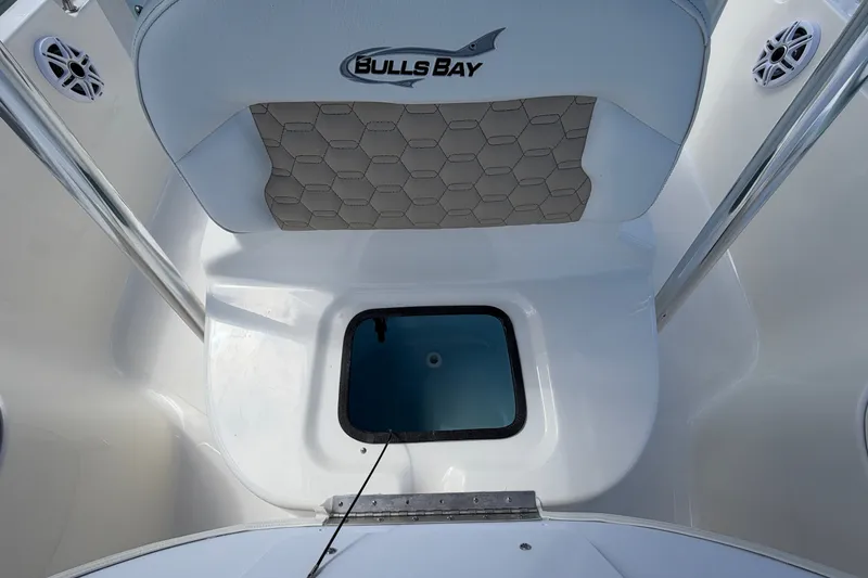 Slide: The Image of 2027 Bulls Bay 2200 XS boat interior with seating and storage compartment. - 14