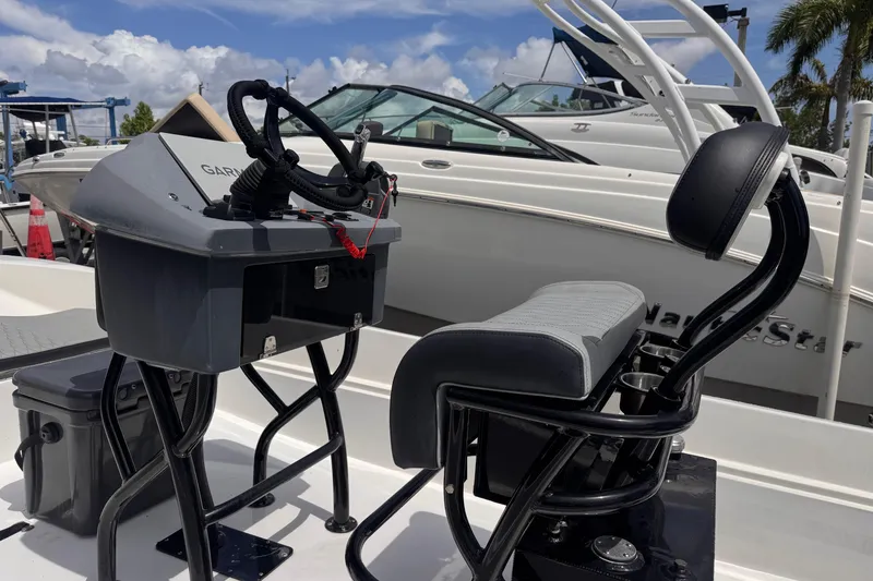 Slide: The Image of 1980 Boston Whaler 17 Montauk boat interior with modern console and seating. - 2