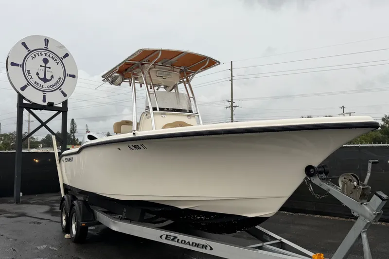 The Image of 2019 Key West 239 FS boat on trailer at dealership, overcast day. - 0