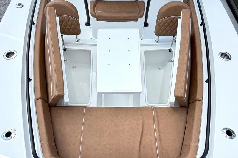 Slide: The Image of 2027 Sea Hunt Ultra 275SE boat interior with brown seating and white table. - 25